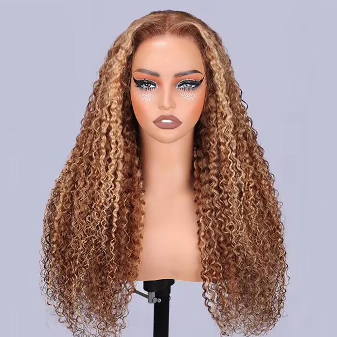 Mannequin head with long, wavy, brown and blonde wig on a gray background