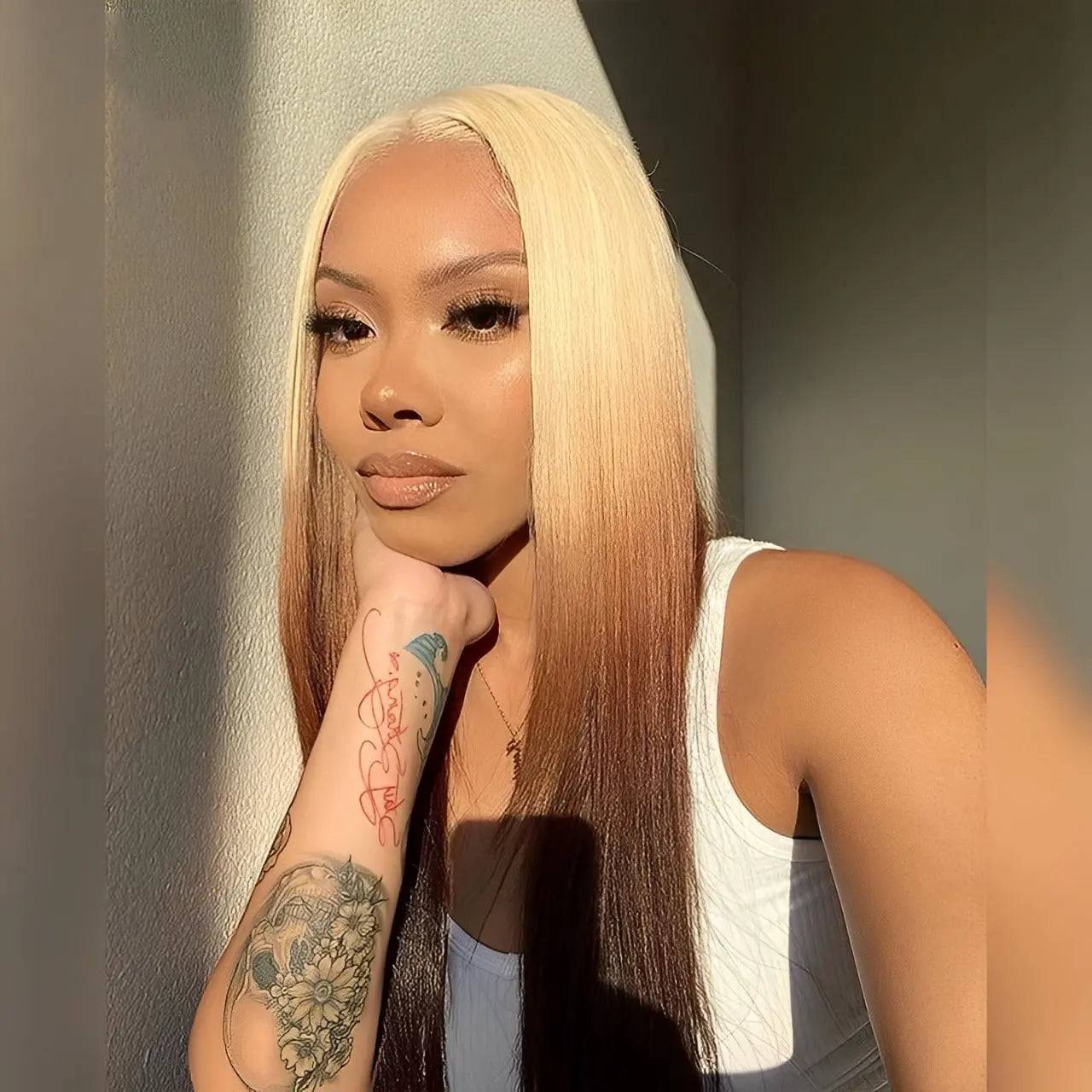 Model wearing a blonde ombre brown transparent pre-plucked middle part wig with a sleek straight style, highlighting its natural blend and soft texture.