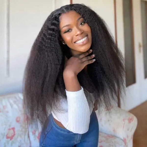 Kinky straight glueless lace closure wig in natural black, styled effortlessly on a smiling model for a voluminous and textured look.