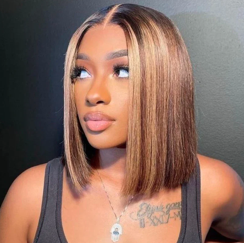 Woman with a styled bob haircut against a dark background