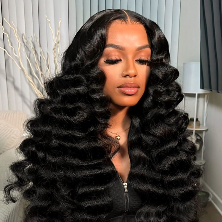 Woman with voluminous black hair styled in loose curls indoors.