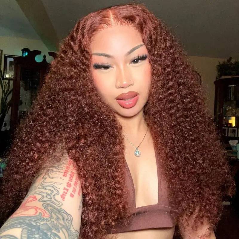 Reddish brown Jerry Curl glueless HD closure wig worn by a model, showcasing voluminous curls and natural hairline.