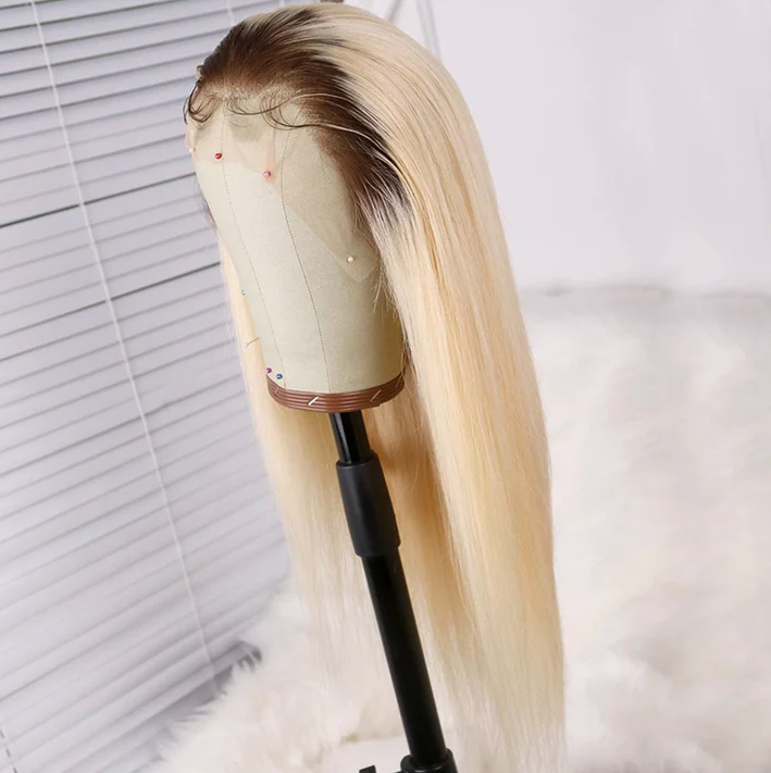 Blonde wig on a mannequin head with a white background
