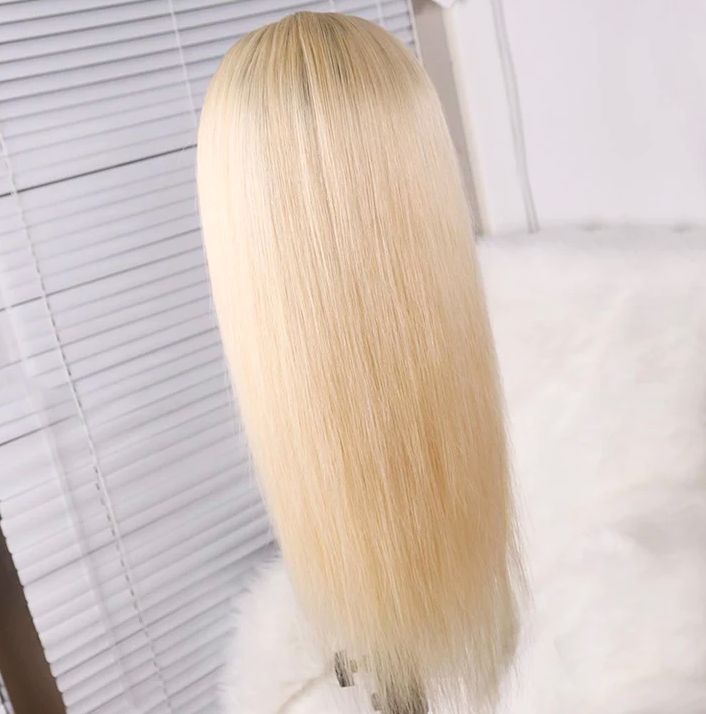 Blonde wig on a mannequin head with a white background