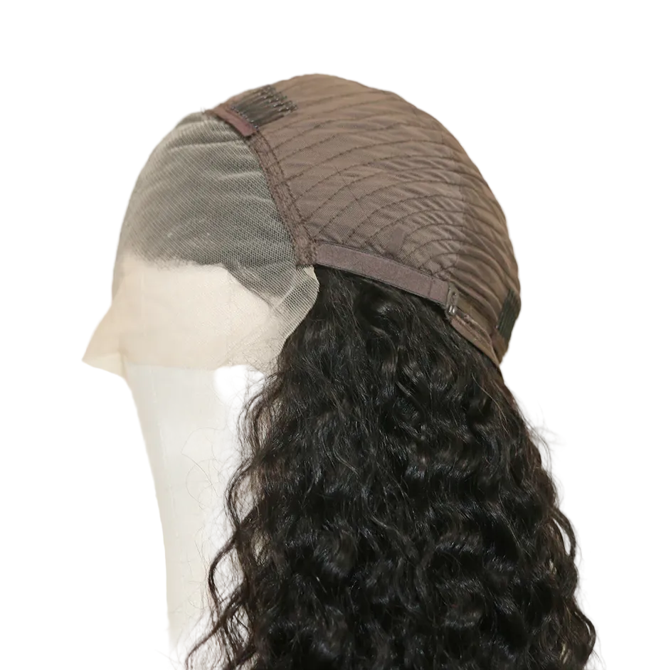 Mannequin head with a brown wig cap and black curly hair on a beige background