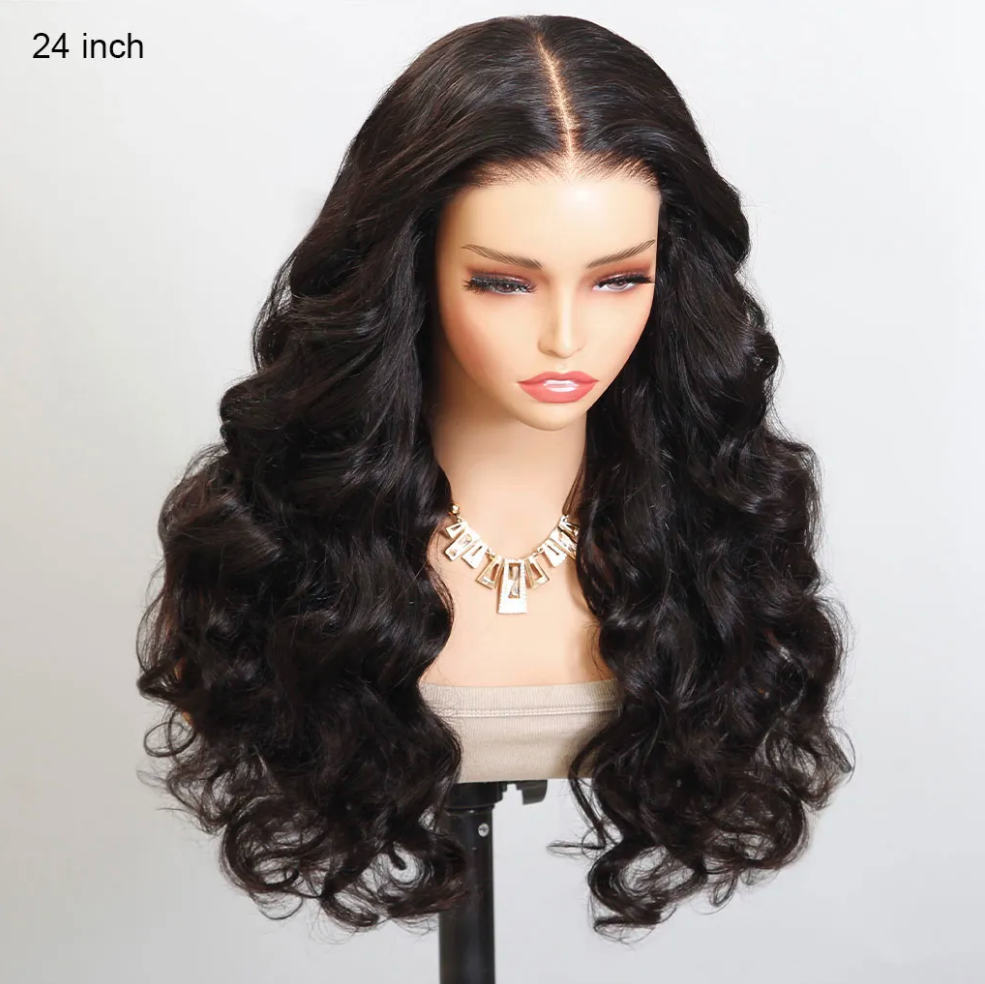 Black wavy wig on a mannequin head with a plain background