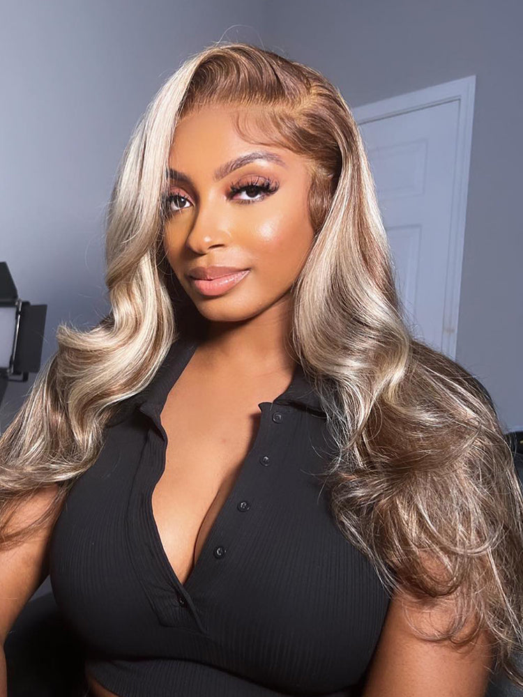 Woman with styled hair wearing a black top indoors.