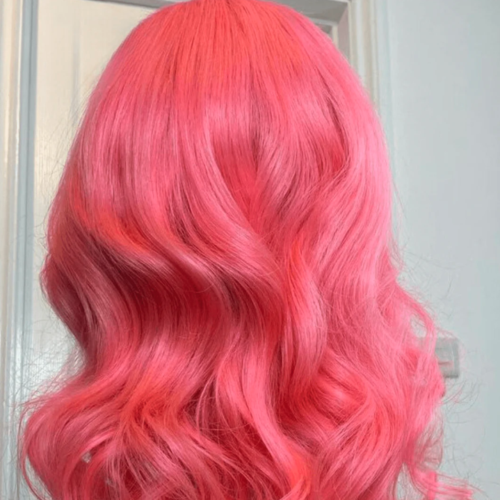 Pink wig with wavy hair against a neutral background