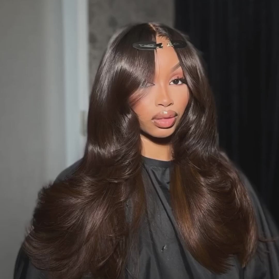 Dark brown body wave wig with curtain bangs, styled in voluminous waves for a natural and effortless look.