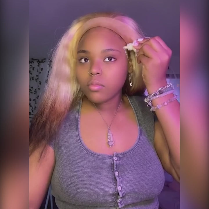 Woman applying a blonde ombre brown transparent pre-plucked body wave middle part wig, demonstrating its natural hairline and easy installation process.