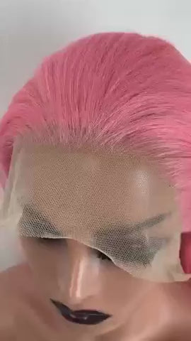 A mannequin modeling a pink wig against a whit background