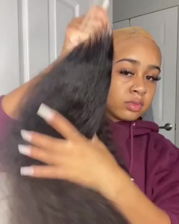 Close-up of a woman holding the Jerry Curly Transparent 13*4 Lace Frontal Virgin Hair Wig, showing its lace front and natural texture before installation.