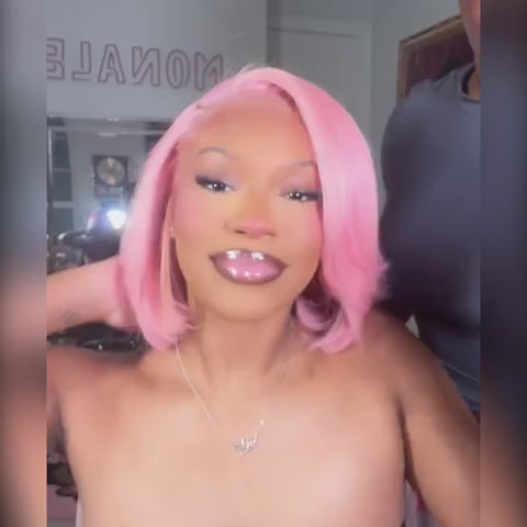 Vibrant light pink straight bob lace frontal wig styled in a playful, voluminous look with soft curls.